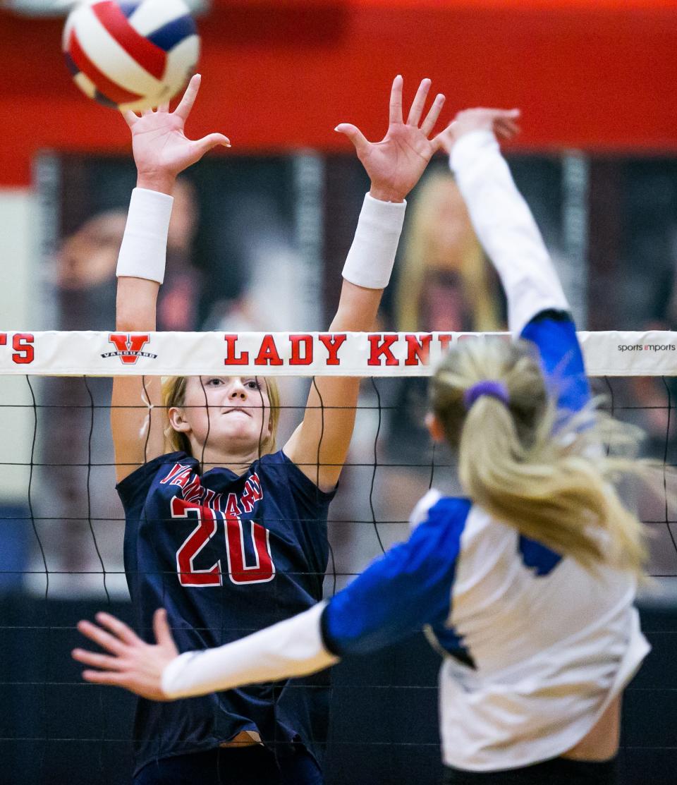 Vanguard's Emma Ehmann (20) blocks an attempt by Ridgeview's Payton Cannon (4) during Wednesday's regional volleyball final.