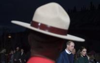 The Duke and Duchess of Cambridge walk past a member of the RCMP in Whitehorse, Yk., Tuesday, Sept 27, 2016. THE CANADIAN PRESS/Jonathan Hayward