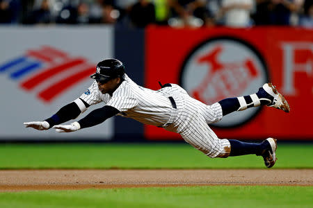 FILE PHOTO: Oct 9, 2018; Bronx, NY, USA; New York Yankees shortstop Didi Gregorius (18) dives into second base for a double during the fourth inning against the Boston Red Sox in game four of the 2018 ALDS playoff baseball series at Yankee Stadium. Mandatory Credit: Noah K. Murray-USA TODAY Sports