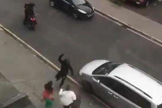 Terrifying moment: A moped thug lunges at his victims with a knife (Twitter)