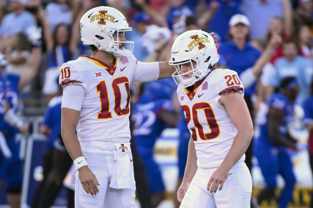 Iowa State place kicker Jace Gilbert (20) walks past teammate Blake Clark (10) after missing a field goal that would have tied the game against Kansas, Saturday, Oct. 1, 2022, in Lawrence, Kan. Kansas won, 14-11. (AP Reed/Hoffmann)