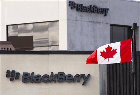 A Canadian flag waves in front of a Blackberry logo at the Blackberry campus in Waterloo, September 23, 2013. REUTERS/Mark Blinch