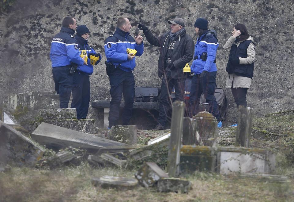 French gendarmes investigate near desecrated tombstones at the Sarre-Union Jewish cemetery, eastern France