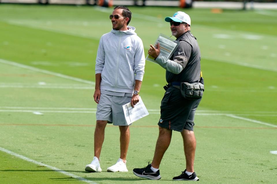 Miami Dolphins head coach Mike McDaniel, left, in his sweatshirt during Thursday's practice.