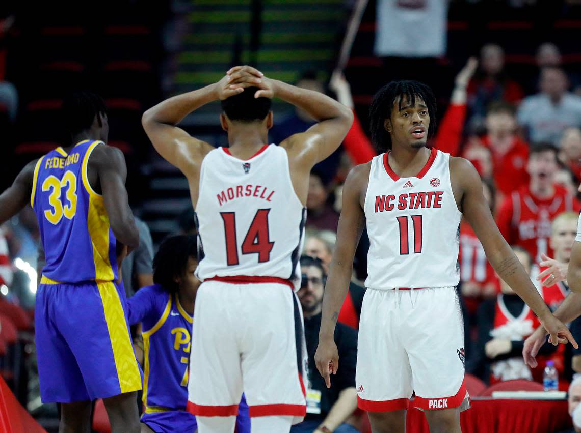 N.C. State’s Casey Morsell and Dennis Parker Jr. react to a foul called against the Wolfpack during the second half of the team’s 67-64 loss to Pittsburgh on Wednesday, Feb. 7, 2024, at PNC Arena in Raleigh, N.C.