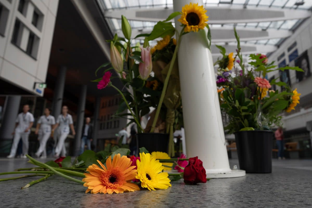 Flowers left at the medical centre in the wake of the killings (AP)