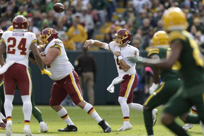 Washington Football Team's Taylor Heinicke thorws a pass during the first half of an NFL football game against the Green Bay Packers Sunday, Oct. 24, 2021, in Green Bay, Wis. (AP Photo/Matt Ludtke)