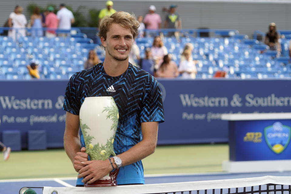 Alexander Zverev, of Germany, holds the trophy after defeating Andrey Rublev, of Russia, in the men's single final of the Western & Southern Open tennis tournament, Sunday, Aug. 22, 2021, in Mason, Ohio. (AP Photo/Darron Cummings)