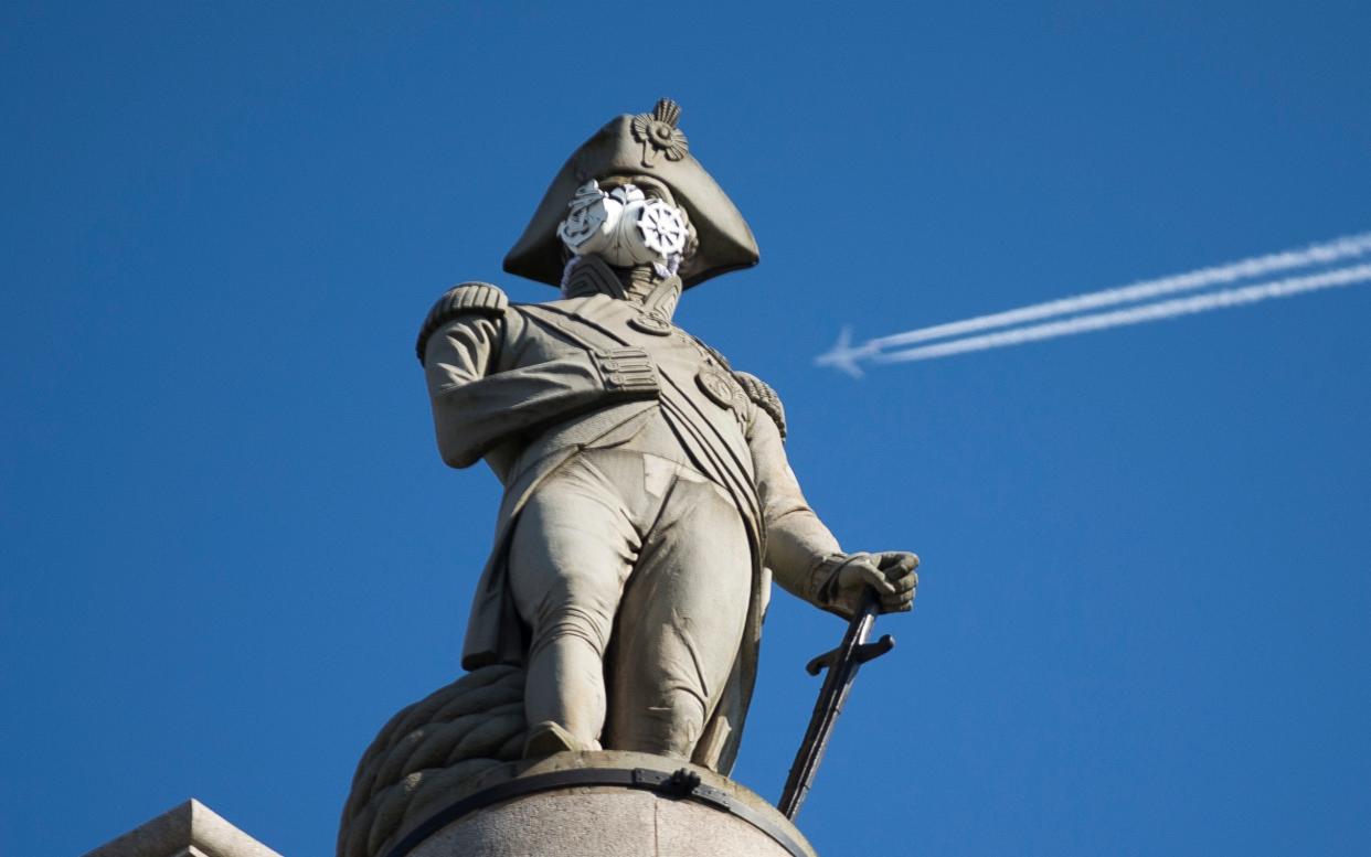 A clean air mask is seen placed on the top of Nelson's Column by Greenpeace activists to protest against air pollution quality -  Matt Dunham/AP