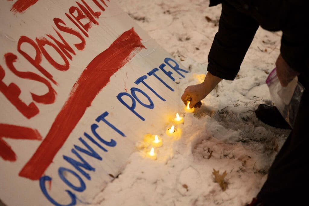 Protesters place electronic candles next to a sign demanding a conviction of former Minneapolis police officer Kim Potter outside of the Hennepin County Government Center on Wednesday, Dec. 22, 2021, in Minneapolis. (AP Photo/Christian Monterrosa)