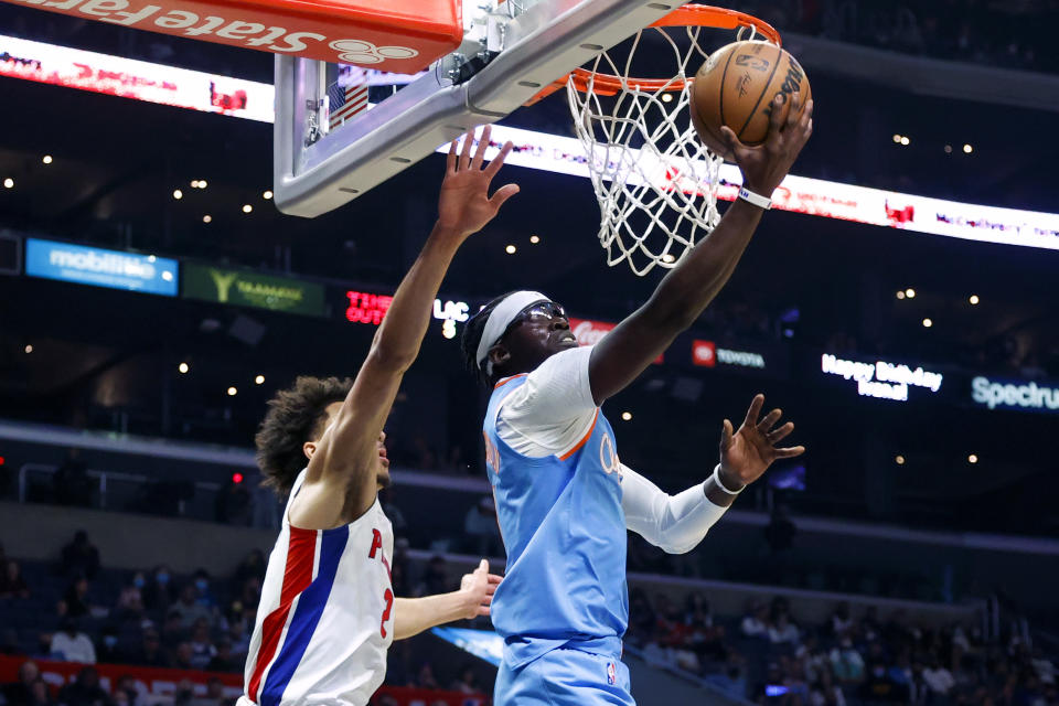 Los Angeles Clippers guard Reggie Jackson, right, goes to basket under pressure from Detroit Pistons guard Cade Cunningham during the second half of an NBA basketball game Friday, Nov. 26, 2021, in Los Angeles. The Clippers won 107-96. (AP Photo/Ringo H.W. Chiu)
