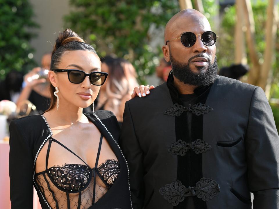 Jeannie Mai-Jenkins and Jeezy pose for a photo together in sleek formalwear.