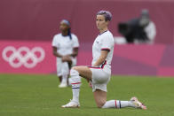 United States players kneel prior to their women's soccer match against Australia at the 2020 Summer Olympics, Tuesday, July 27, 2021, in Kashima, Japan. (AP Photo/Fernando Vergara)