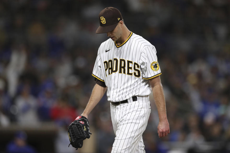 San Diego Padres relief pitcher Taylor Rogers reacts as he walks to the dugout at the end of the eighth inning of a baseball game against the Los Angeles Dodgers, Saturday, April 23, 2022, in San Diego. (AP Photo/Derrick Tuskan)