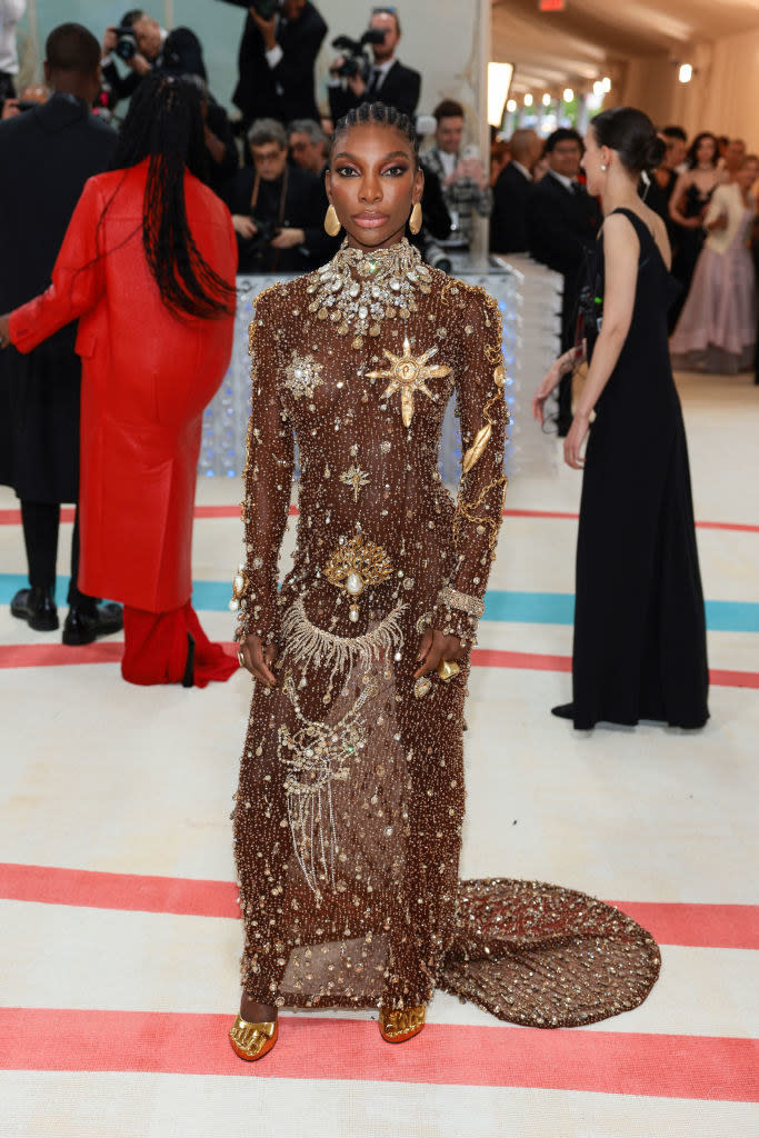 Michaela Coel attends The 2023 Met Gala in a golden gown