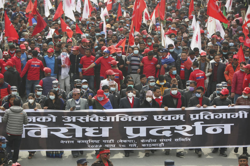Supporters of a splinter group of Nepal's Communist Party walk behind their leaders at a rally in Kathmandu, Nepal, Wednesday, Feb.10, 2012. (AP Photo/Niranjan Shrestha)