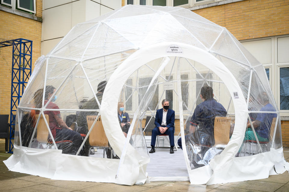 <p>LONDON, ENGLAND - MARCH 15: Labour Party leader Keir Starmer speaks with nurses and midwives inside a pop-up dome during a visit to the Whittington hospital on March 15, 2021 in London, England. The Labour Party has proposed a pay increase of at least 2.1%, following the Governments decision to offer a capped 1% pay rise to NHS workers, which critics have stated is an real terms pay cut when interest rates are considered. (Photo by Leon Neal/Getty Images)</p>
