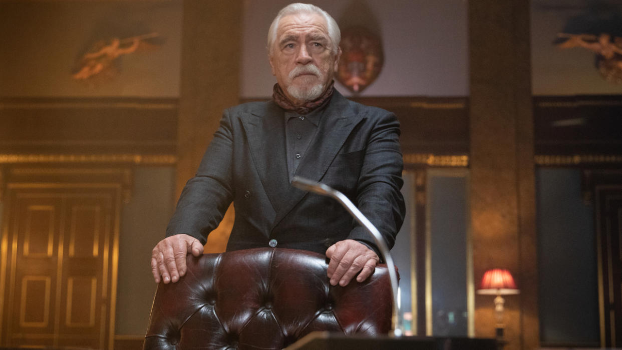  Brian Cox stands behind an imposing leather chair in 007: Road to a Million. 