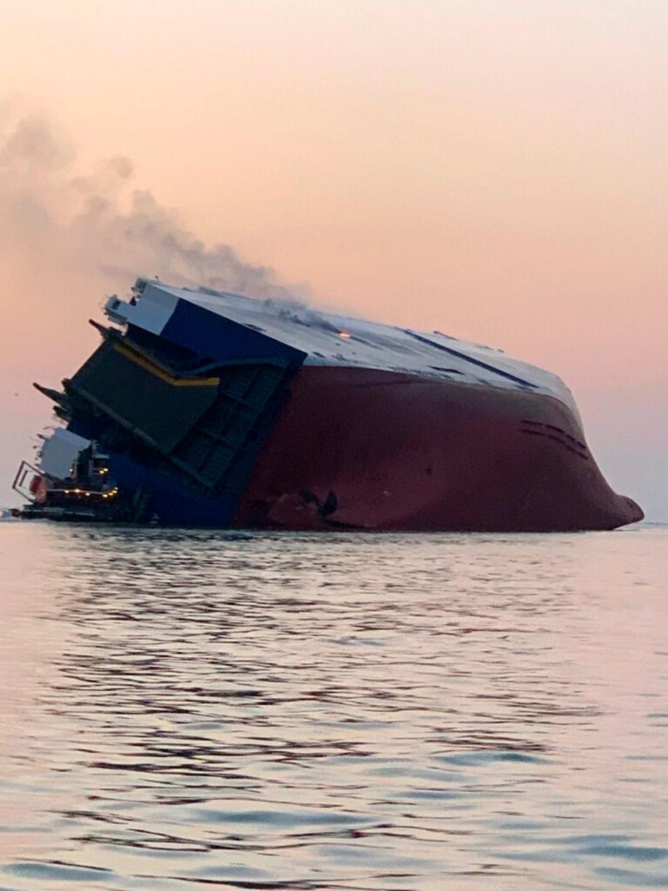 Coast Guard crews and port partners respond to an overturned cargo vessel with a fire on board on Sept. 8, 2019, in St. Simons Sound, Ga.