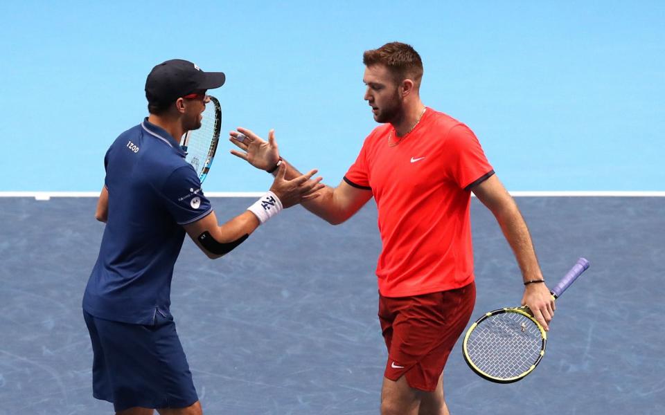 Jack Sock, right, congratulates Mike Bryan during their victory over Oliver Marach and Mate Pavic at the ATP World Tour Finals - PA