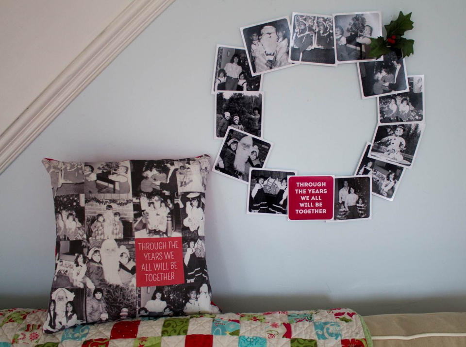 In this photo taken on Dec. 2, 2013, a simple series of black and white pictures becomes an elegant holiday wreath when glued to a cardboard ring and embellished with a bit of faux holly. The holidays are a great time to pull out the old photos and reminisce, but there's no need to huddle around a dusty album. (AP Photo/Holly Ramer)