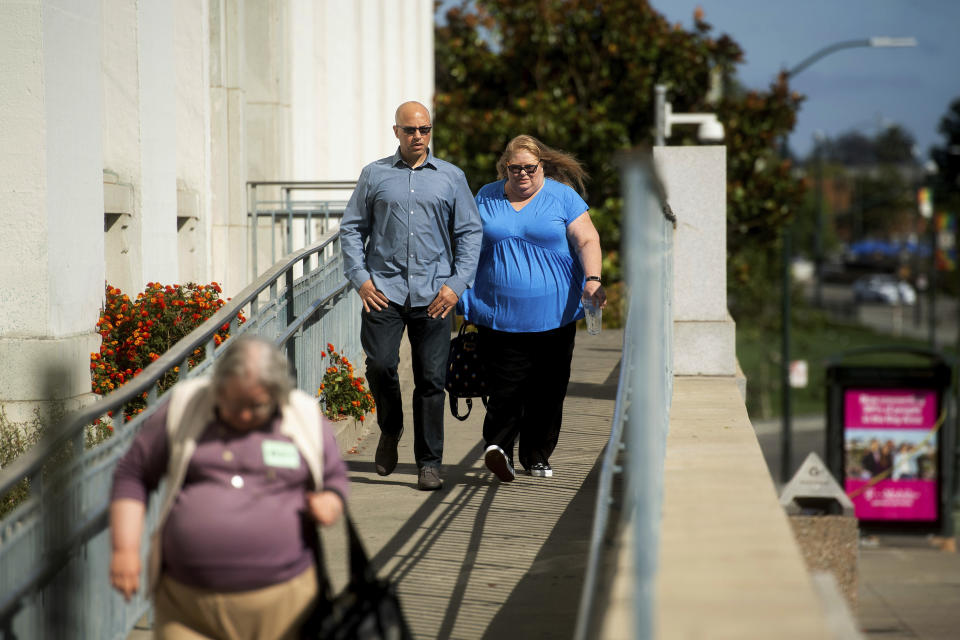 David Gregory, who's daughter Michela Gregory died in the 2016 Ghost Ship warehouse fire, leaves Alameda County Superior Court on Monday, Aug. 19, 2019, in Oakland, Calif. At right is Karen Bourdon Frieholtz. Three jurors were dismissed Monday for undisclosed reasons on the 10th day of deliberations in the trial of two men charged in the deaths of 36 partygoers from a fire inside a cluttered San Francisco Bay Area warehouse. (AP Photo/Noah Berger)