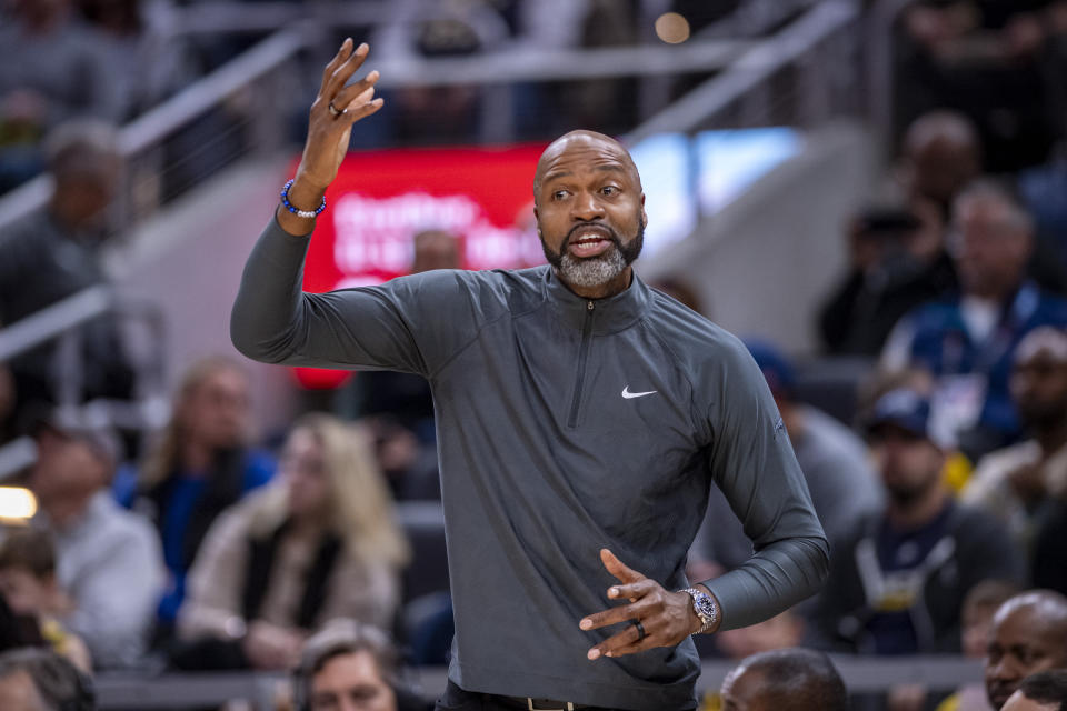 Orlando Magic head coach Jamahl Mosley gestures to players on the court during the first half of an NBA basketball game against the Indiana Pacers in Indianapolis, Sunday, Nov. 19, 2023. (AP Photo/Doug McSchooler)