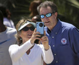 FILE - In this Saturday, May 23, 2020 file photo, Gov. Ralph Northam and Tori Bloxom, of Onancock, Va., take a selfie as the governor visits the Oceanfront in Virginia Beach, Va., to see for himself how crowded the beach was. Northam has repeatedly urged Virginia residents to cover their faces in public during the COVID-19 pandemic, but the Democrat didn't heed his own plea when he posed mask-less for photographs alongside residents during the weekend beach visit. From the U.S. president to the British prime minister's top aide and far beyond, leading officials around the world are refusing to wear masks or breaking confinement rules meant to protect their populations from the coronavirus and slow the pandemic. While some are punished when they're caught, or publicly repent, others shrug off the violations as if the rules don't apply to them. (Stephen M. Katz/The Virginian-Pilot via AP, File)