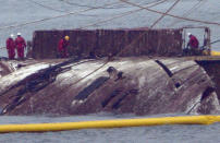 A part of the sunken Sewol ferry is seen in waters off Jindo, South Korea, Thursday, March 23, 2017. Nearly three years after it capsized and sank into the violent seas off South Korea’s southwestern coast, workers slowly pulled up the 6,800-ton ferry Sewol from the waters on Thursday. (Korea Pool/Yonhap via AP)