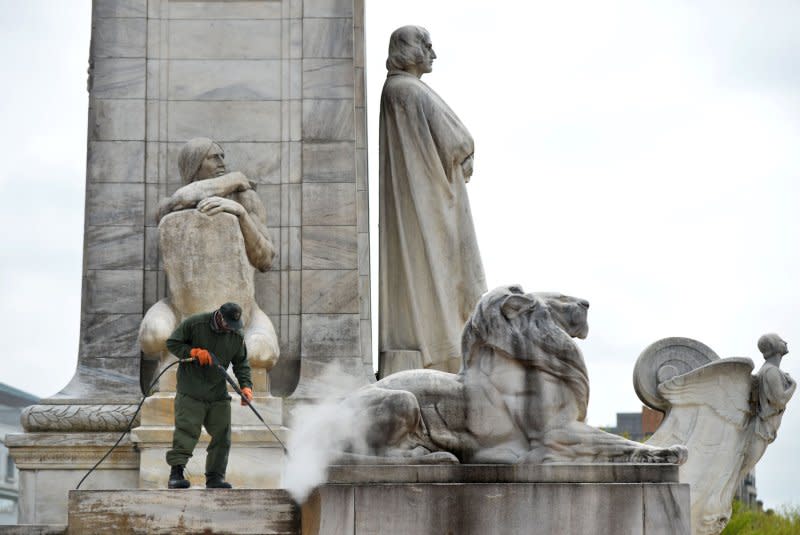 A National Park Service employee cleans the Christopher Columbus Memorial Fountain in front of Union State, on April 23, 2013 in Washington, D.C. On October 12, 1492, Columbus reached America, making his first landing in the New World on one of the Bahamas Islands. Columbus thought he had reached India. File Photo by Kevin Dietsch/UPI