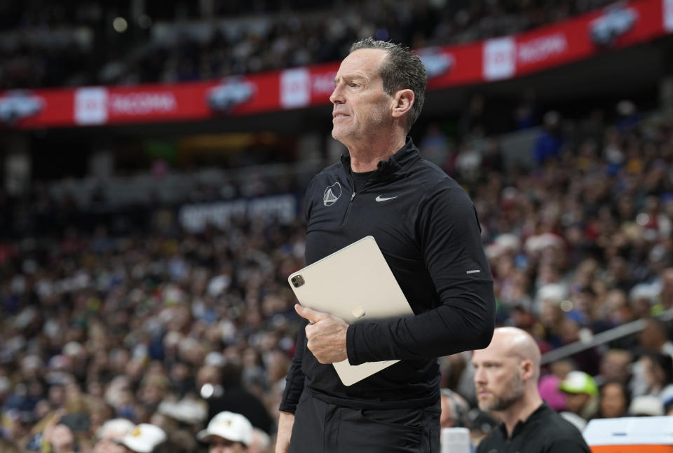 FILE - Golden State Warriors assistant coach Kenny Atkinson watches during the first half of the team's NBA basketball game against the Denver Nuggets on Dec. 25, 2023, in Denver. The Cleveland Cavaliers are hiring Golden State assistant Kenny Atkinson as their new coach, a person familiar with decision told the Associated Press on Monday, June 24, 2024. (AP Photo/David Zalubowski, File)