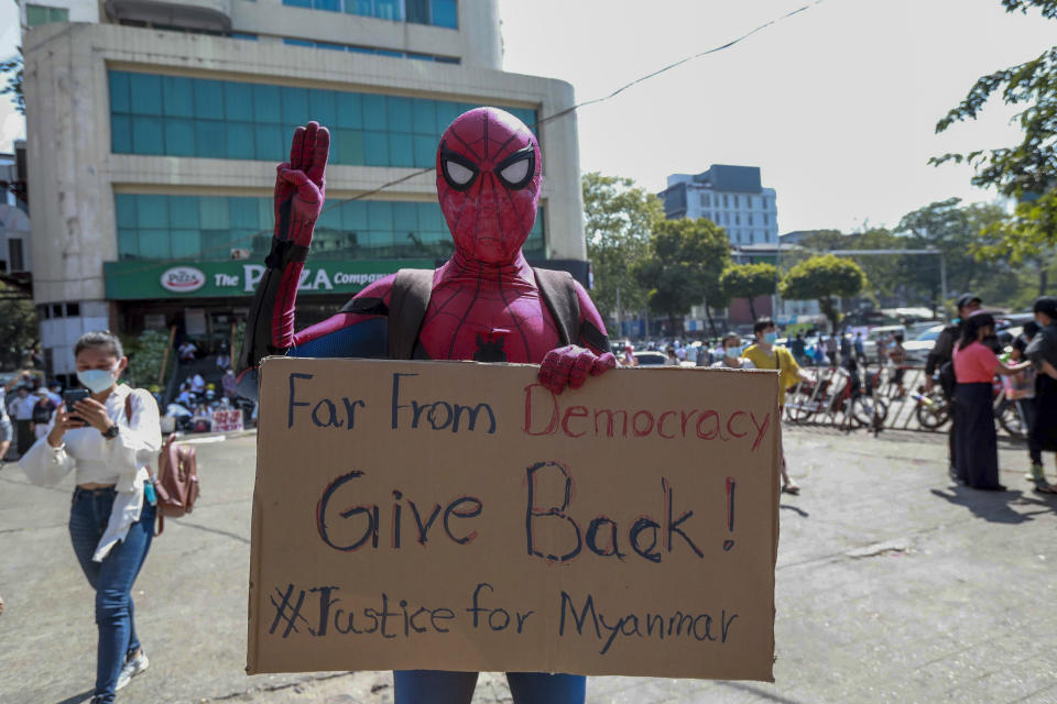 A demonstrator in a costume flashes three-fingered salute, a symboled of resistance, in Yangon, Myanmar Wednesday, Feb. 10, 2021. Protesters continued to gather Wednesday morning in Yangon breaching Myanmar's new military rulers' decrees that effectively banned peaceful public protests in the country's two biggest cities. (AP Photo)