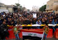 Supporters of Iraqi Shi'ite cleric Moqtada al-Sadr gather near his home, after it was attacked, in the holy city of Najaf