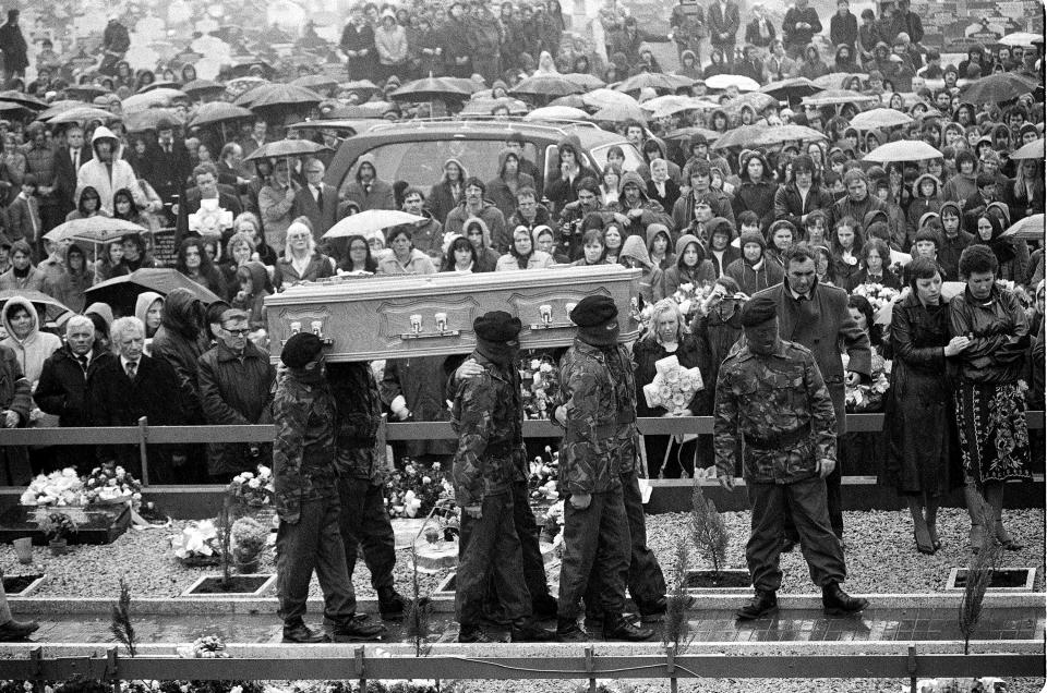 FILE - The coffin containing the body of hunger striker Bobby Sands is carried to the grave by six masked IRA men at Belfast's Milltown Cemetery Thursday, May 7, 1981. Caulkin, a retired Associated Press photographer has died. He was 77 and suffered from cancer. Known for being in the right place at the right time with the right lens, the London-based Caulkin covered everything from the conflict in Northern Ireland to the Rolling Stones and Britain’s royal family during a career that spanned four decades. (AP Photo/Dave Caulkin, File)