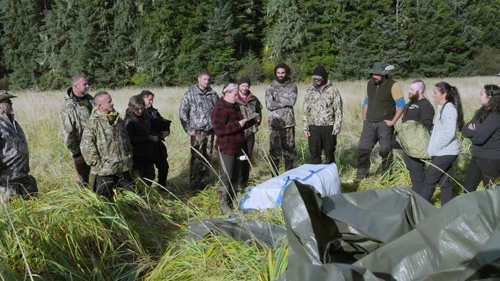 <span class="article__caption">The survivalists read the rules before teaming up in episode one. Courtesy of Netflix (c) 2023</span>