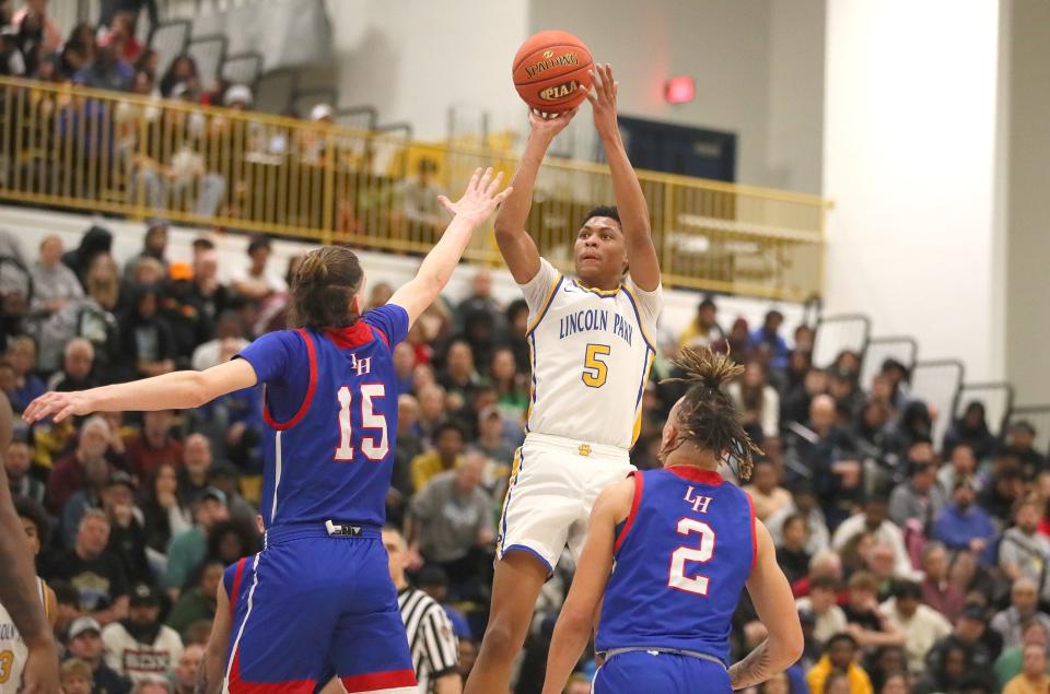 Lincoln Park's Meleek Thomas (5) shoots a three point shot over the head of Laurel Highland's Patrick Cavanagh (15) during the first half of the PIAA 4A Quarterfinals game Friday night at Hampton High School in Allison Park, PA.