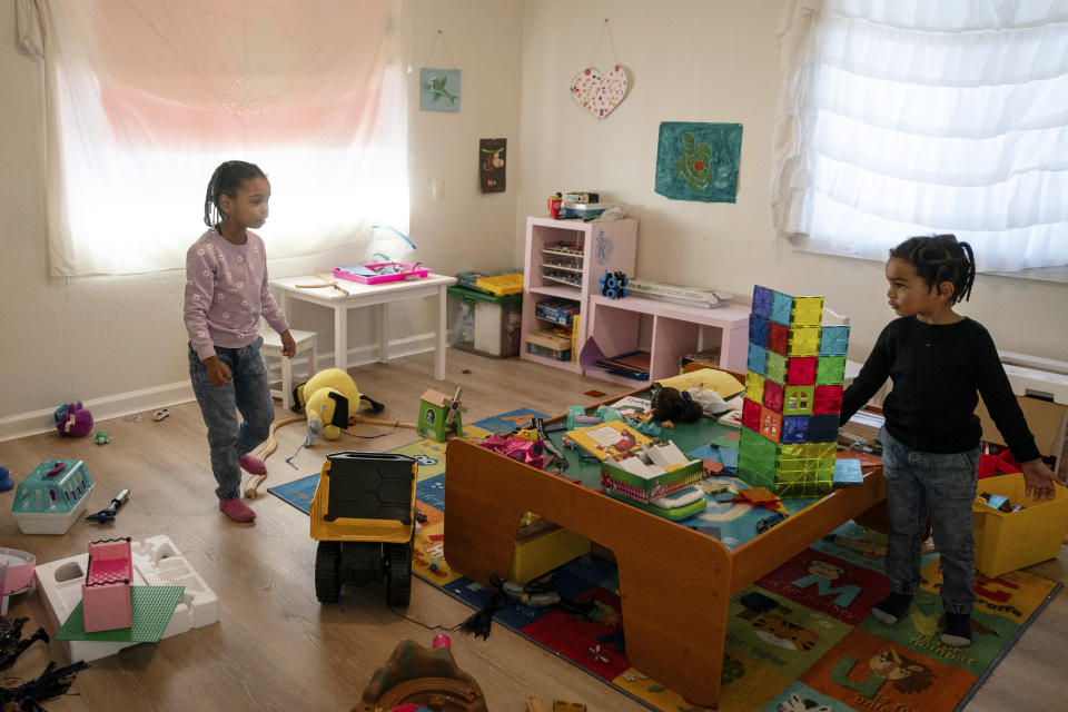 Neveah, left, 6, and brother, Choncey, 4, play at home in Oakland, Calif., on Friday Nov. 24, 2023. (AP Photo/Loren Elliott)