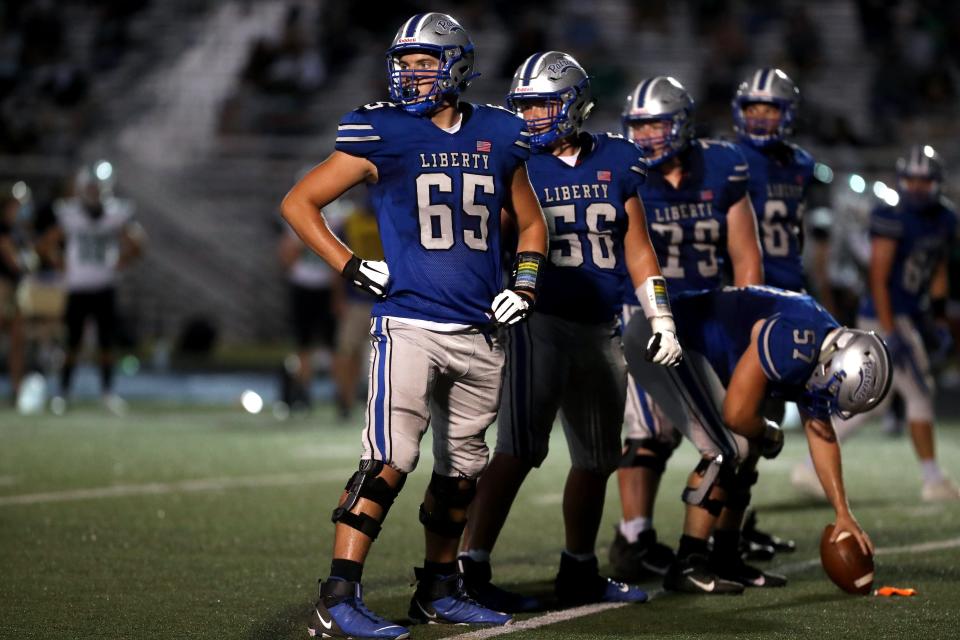 Olentangy Liberty's Carter Smith (65), Ryan Repasky (56) and the rest of the offensive line look to the sideline for the play before getting set during a game against Dublin Coffman on Sept. 4, 2020, at Olentangy Liberty High School in Powell, Ohio.