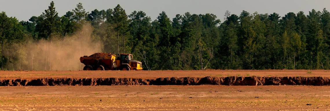 A truck hauls dirt as excavation work continues at the VinFast site.