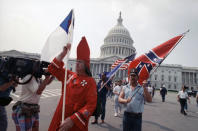 <p>About 40 members of the Ku Klux Klan some robes and hoods hold a brief rally on the U.S. Capitol grounds in Washington D.C., Sept. 3, 1990. Police cancelled a planned Klan march through downtown amid strong counter protests. (Photo: Marcy Nighswander/AP) </p>
