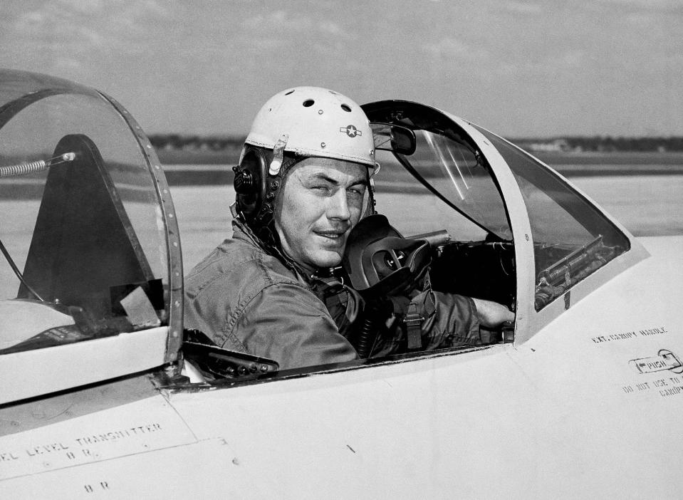 FILE - In this 1948 file photo, test pilot Charles E. Yeager, 25, poses for a picture in a jet's cockpit. Yeager was first to fly faster than the speed of sound. Another Yeager feat, flying a jet under a Charleston, W.Va., bridge in 1948, was not reported by the local media. Yeager died Monday, Dec. 7, 2020, at age 97. (AP Photo/File)