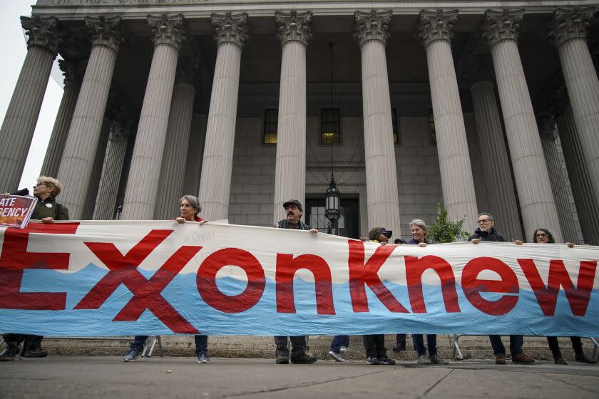 NEW YORK, NY - OCTOBER 22: Environmental activists rally for accountability for fossil fuel companies outside of New York Supreme Court on October 22, 2019 in New York City. Tuesday is the first day of a trial where New York's attorney general is taking on ExxonMobil in a landmark case that accuses the oil corporation of misleading investors about the companys financial risks due to climate change. (Photo by Drew Angerer/Getty Images)