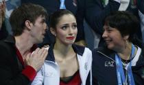 Stefania Berton (C) and Ondrej Hotarek (L) of Italy react at the kiss and cry after their figure skating team pairs free skating at the Sochi 2014 Winter Olympics, February 8, 2014. REUTERS/Lucy Nicholson (RUSSIA - Tags: SPORT OLYMPICS SPORT FIGURE SKATING)