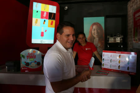 Presidential candidate Fabricio Alvarado Munoz of the National Restoration Party (PRN) visits a popsicle store in San Jose, Costa Rica, March 31, 2018. REUTERS/Jose Cabezas