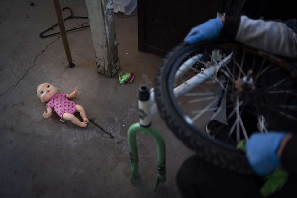 A doll belonging to a grandchild of Norma Flores lies on the ground in the backyard of her home in Henderson, Nev., Tuesday, Nov. 10, 2020. Flores is a Mexican immigrant who spent two decades working as a waitress at the Fiesta before COVID-19 descended and she lost her job. At night, she often lies awake, worrying about paying the rent, buying gas, getting enough food. Like millions of other people across the U.S., her unemployment benefits run out the day after Christmas. She's terrified her family could end up homeless. (AP Photo/Wong Maye-E)