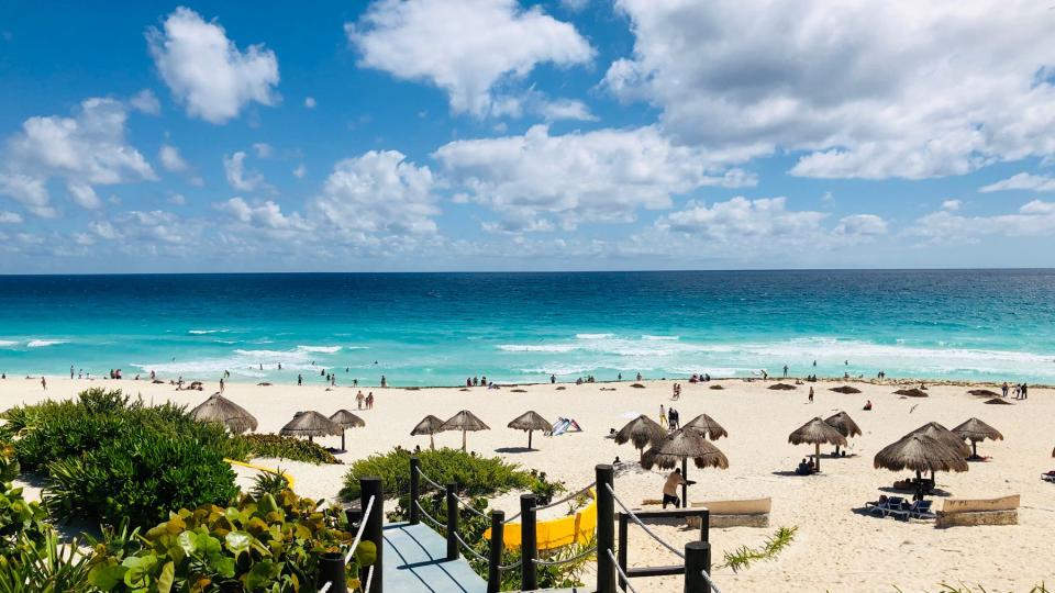 A general view from one of the accesses to the beach area with palapa umbrellas in Cancun, Quintana Roo State, Mexico, on February 16, 2019