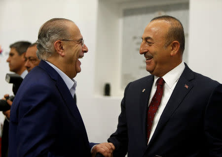 Foreign Minister of Cyprus Ioannis Kasoulides (L) talks with Turkey's Foreign Minister Mevlut Cavusoglu before a meeting with European Union Foreign Ministers in Valletta, Malta April 28, 2017. REUTERS/Darrin Zammit Lupi