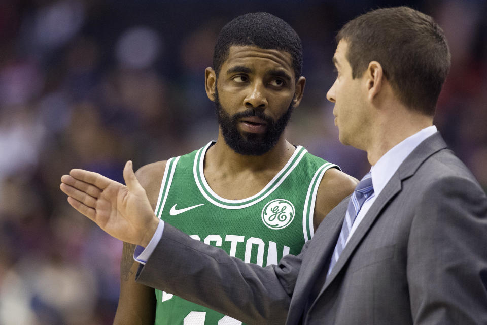 Boston Celtics guard Kyrie Irving and head coach Brad Stevens talk during the second half of an NBA basketball game against the Washington Wizards, Wednesday, Dec. 12, 2018, in Washington. The Celtics won 130-125 in overtime. (AP Photo/Alex Brandon)