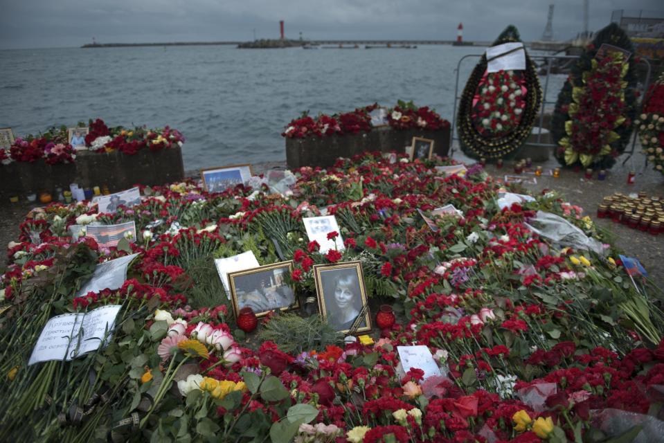 Flowers, candles and portraits are placed at a pier in honour of the victims of the military plane crash, in Sochi, Russia, in Sochi, Russia, Wednesday, Dec. 28, 2016. All 84 passengers and eight crew members on the Russian military's Tu-154 plane are believed to have died Sunday morning when it crashed two minutes after taking off from the southern Russian city of Sochi. (AP Photo/Viktor Klyushin)