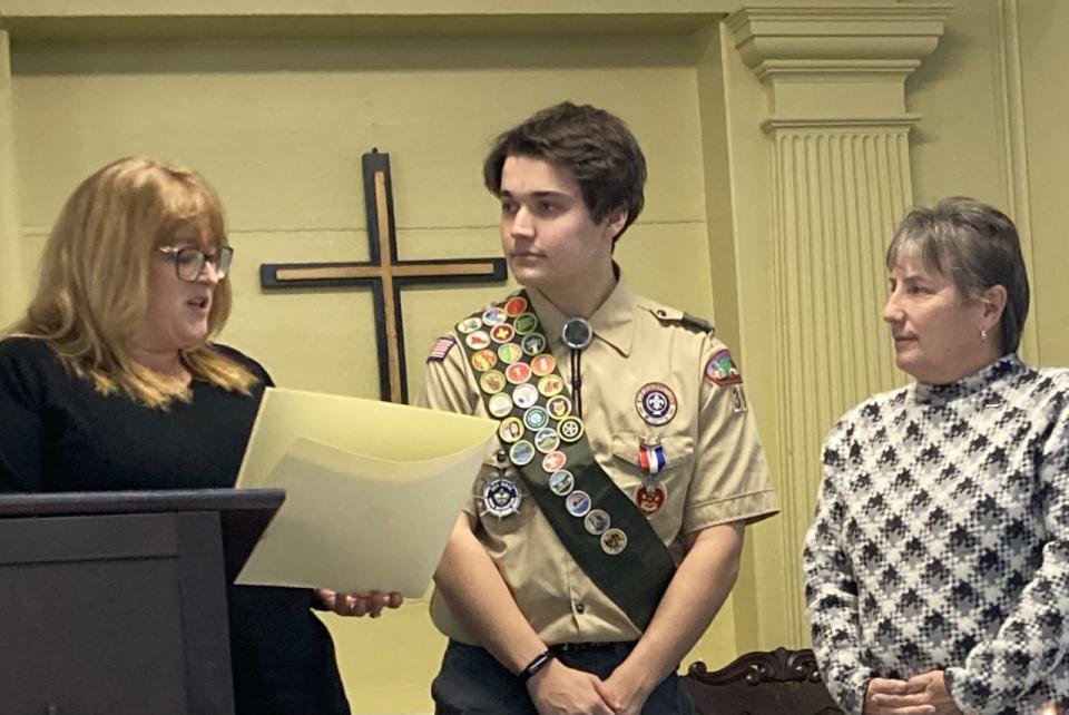 State Rep. Susannah Whipps and state Sen. Anne Gobi present citations to Eagle Scout John Bennett.